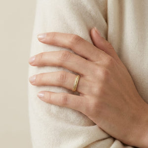 2mm High Polish Carved Wedding Band in 14K Yellow Gold, worn on hand, full view