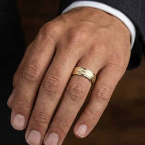 6mm High Polish Round Edge Carved Wedding Band in 14K Yellow Gold, worn on hand, masculine close-up