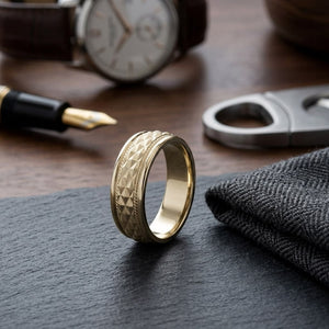 8mm High Polish Cross Hatch Center Carved Wedding Band in 14K Yellow Gold, on walnut surface with pocket square