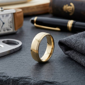 6.5mm Drop Edge High Polish Carved Wedding Band in 14K Yellow Gold, on walnut surface with pocket square