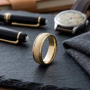 7mm Florentine Center High Polish Round Edge Carved Wedding Band in 14K Yellow Gold, on walnut surface with pocket square