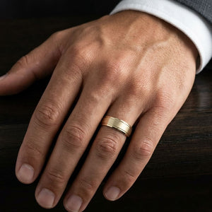8mm Satin Finish Carved Wedding Band in 14K Yellow Gold, worn on hand, masculine close-up