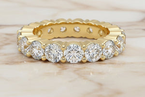 Round brilliant natural diamond eternity band in 14K yellow gold, profile