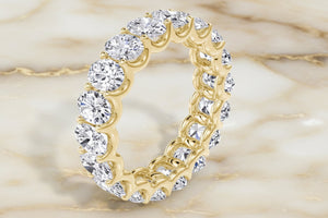 Oval cut natural diamond eternity band in 14K yellow gold, profile