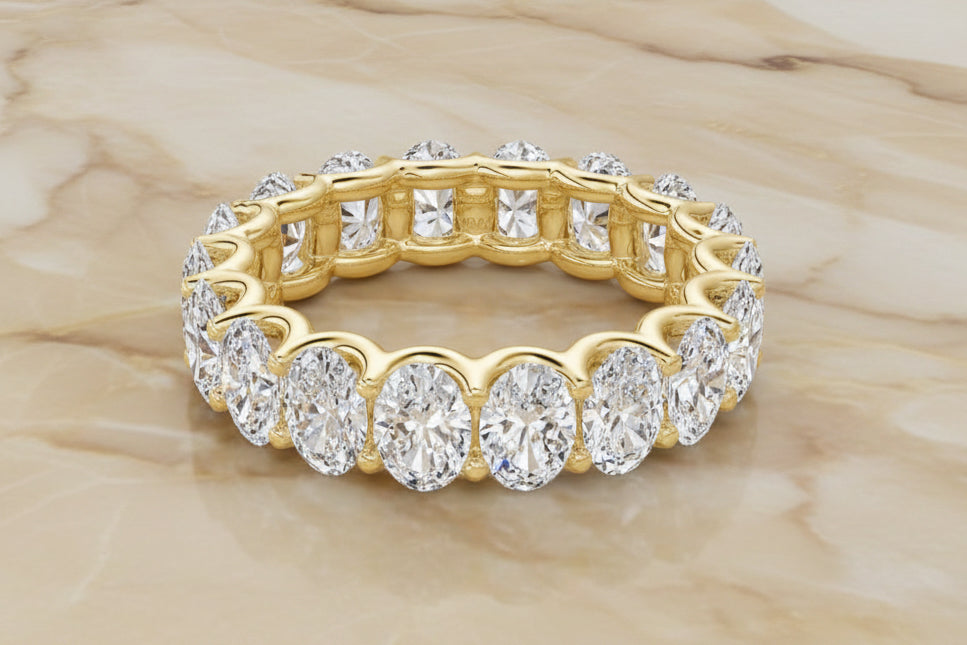 Oval cut natural diamond eternity band in 14K yellow gold — front