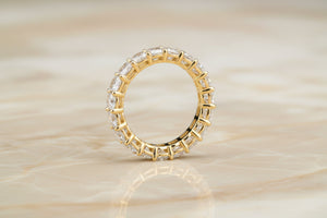 Cushion cut natural diamond eternity band in 14K yellow gold, profile