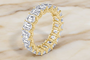 Emerald cut natural diamond eternity band in 14K yellow gold, profile