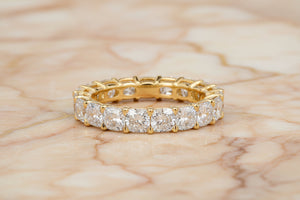 Cushion cut natural diamond eternity band in 14K yellow gold, front