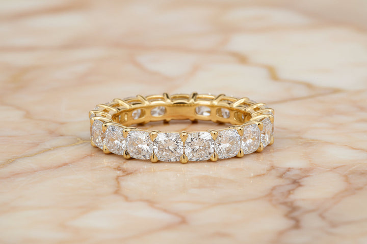 Cushion cut natural diamond eternity band in 14K yellow gold — front