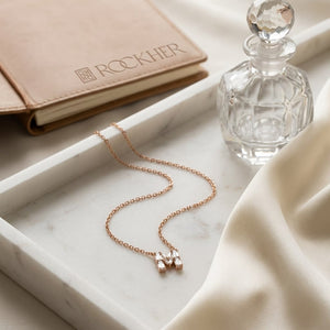 Diamond Letter Pendant Necklace, on marble vanity tray with silk