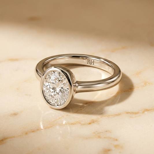 The Agnes bezel solitaire oval engagement ring setting in platinum — alt-angle hero — RockHer
