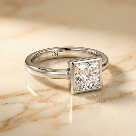 The Agnes bezel solitaire princess engagement ring setting in platinum — alt-angle hero — RockHer