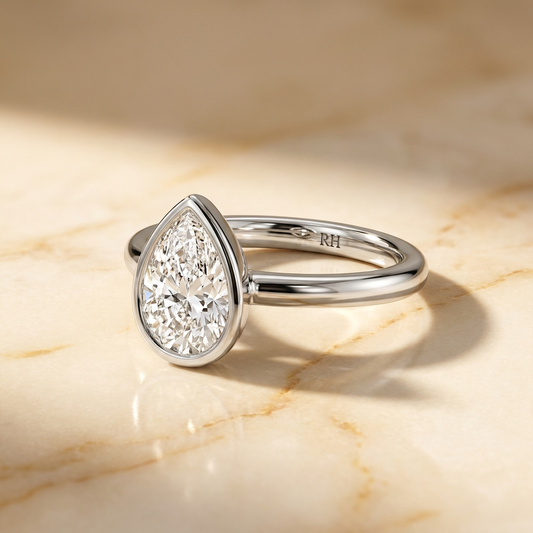 The Agnes bezel solitaire pear engagement ring setting in 18k white gold — alt-angle hero — RockHer
