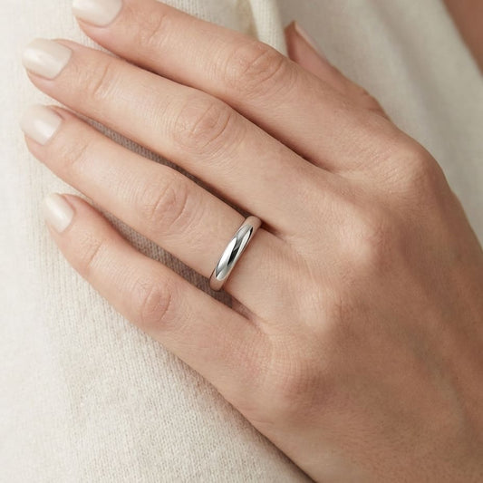 2.5mm Slightly Domed Traditional Oval Wedding Band in Platinum, worn on hand, close-up