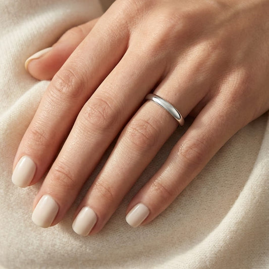 3mm Slightly Domed Traditional Oval Wedding Band in Platinum, worn on hand, close-up