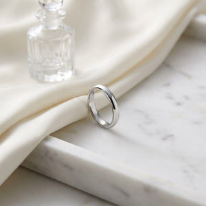 3mm Slightly Domed Traditional Oval Wedding Band in Platinum, on marble vanity tray with silk