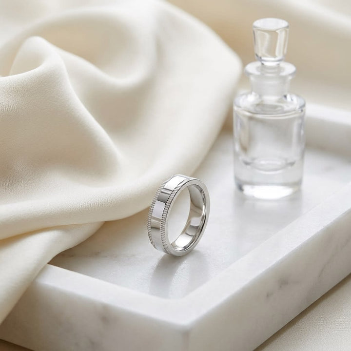 4mm Flat Milgrain Comfort-Fit Wedding Band in Platinum, on marble vanity tray with silk