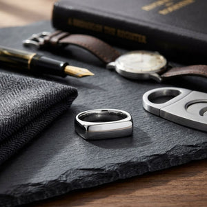 6.5mm Deluxe Comfort-Fit Wedding Band in Platinum, on walnut surface with pocket square