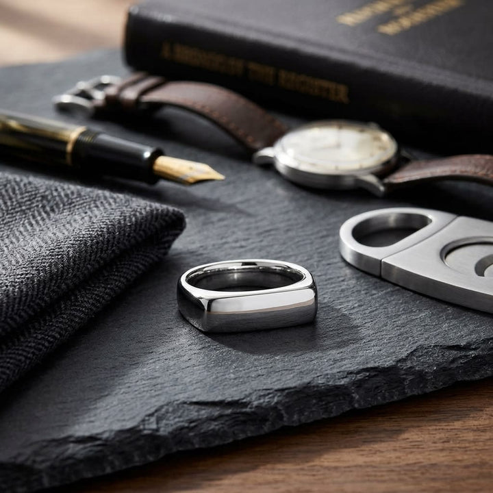 6.5mm Deluxe Comfort-Fit Wedding Band in Platinum, on walnut surface with pocket square
