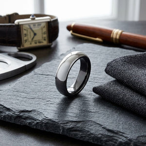 6mm High Dome Comfort-Fit Wedding Band in Platinum, on walnut surface with pocket square