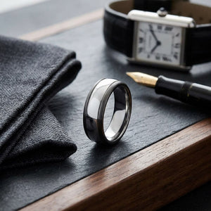7mm High Dome Comfort-Fit Wedding Band in Platinum, on walnut surface with pocket square