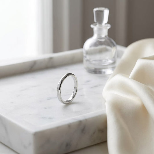 3mm Slightly Domed Comfort-Fit Wedding Band in Platinum, on marble vanity tray with silk