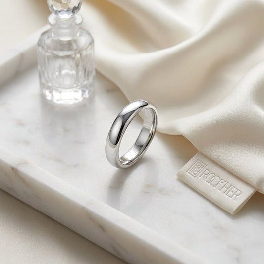 4mm Slightly Domed Comfort-Fit Wedding Band in Platinum, on marble vanity tray with silk