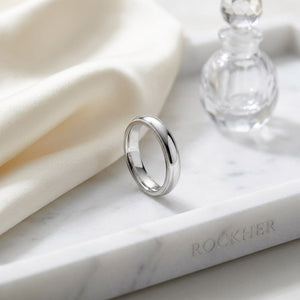 4mm Slightly Domed Double Milgrain Comfort-Fit Wedding Band in Platinum, on marble vanity tray with silk