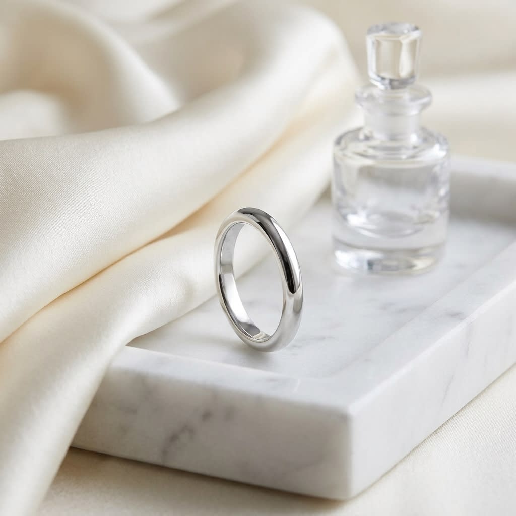 3mm Slightly Domed Super Light Comfort-Fit Wedding Band in Platinum, on marble vanity tray with silk