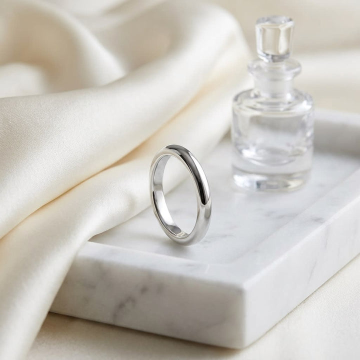3mm Slightly Domed Super Light Comfort-Fit Wedding Band in Platinum, on marble vanity tray with silk