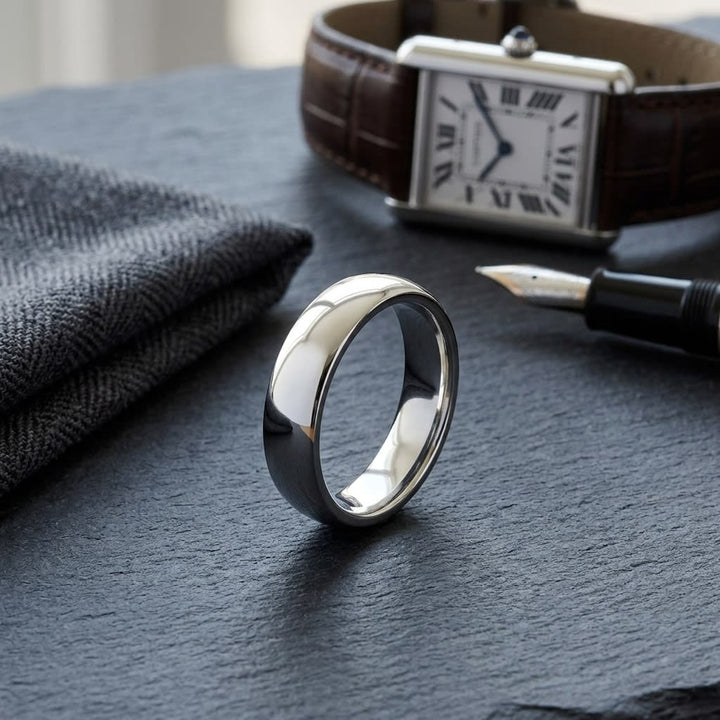 5mm Slightly Domed Super Light Comfort-Fit Wedding Band in Platinum, on walnut surface with pocket square