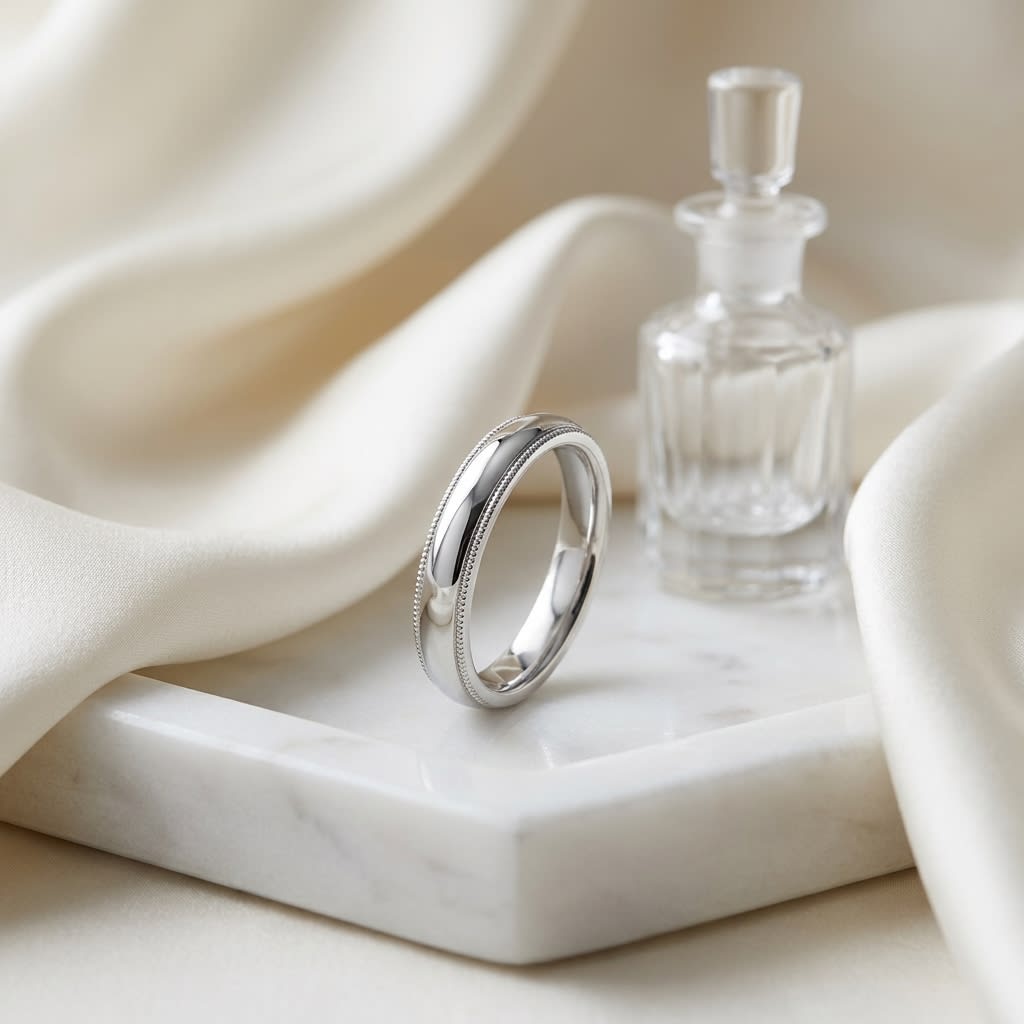 4mm Slightly Domed Super Light Milgrain Comfort-Fit Wedding Band in Platinum, on marble vanity tray with silk