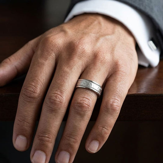 8mm Hammered Center High Polish Round Edge Carved Wedding Band in Platinum, worn on hand, masculine close-up