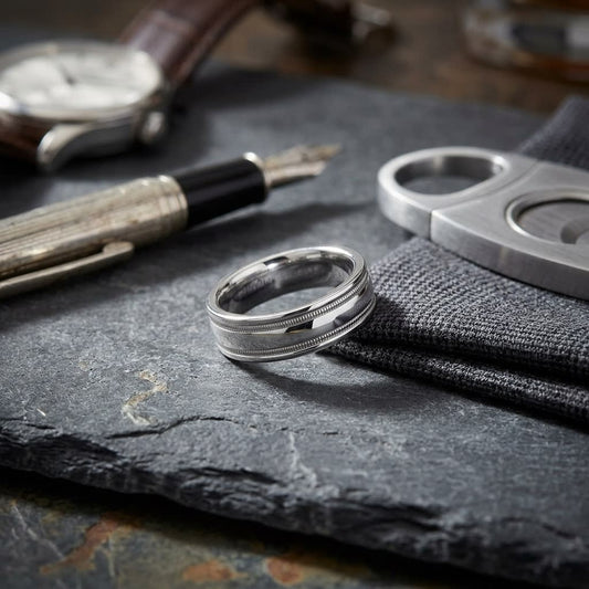 6mm High Polish Milgrain Round Edge Carved Wedding Band in Platinum, on walnut surface with pocket square