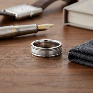 6mm Satin Finish Milgrain Round Edge Carved Wedding Band in Platinum, on walnut surface with pocket square