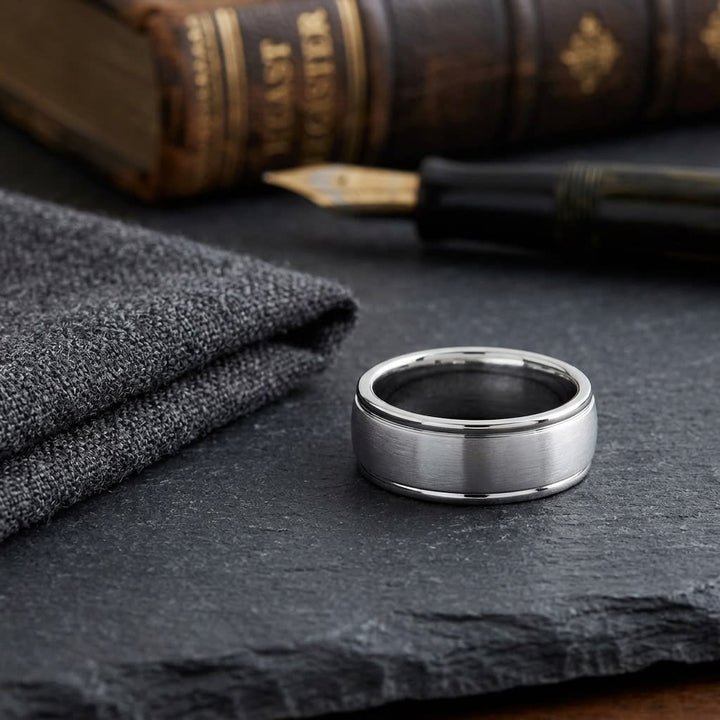 8mm Satin Finish High Polished Round Edge Carved Wedding Band in Platinum, on walnut surface with pocket square
