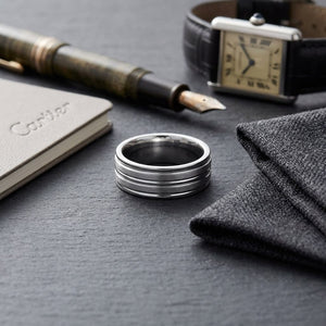 8mm Satin Finish High Polished Center Trim Carved Wedding Band in Platinum, on walnut surface with pocket square
