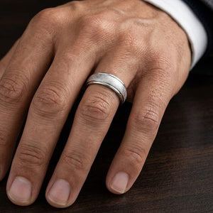 6.5mm Round Edge Swirl Finish Carved Wedding Band in Platinum, worn on hand, masculine close-up