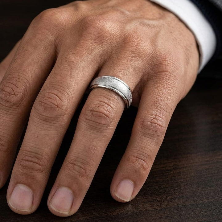 6.5mm Round Edge Swirl Finish Carved Wedding Band in Platinum, worn on hand, masculine close-up