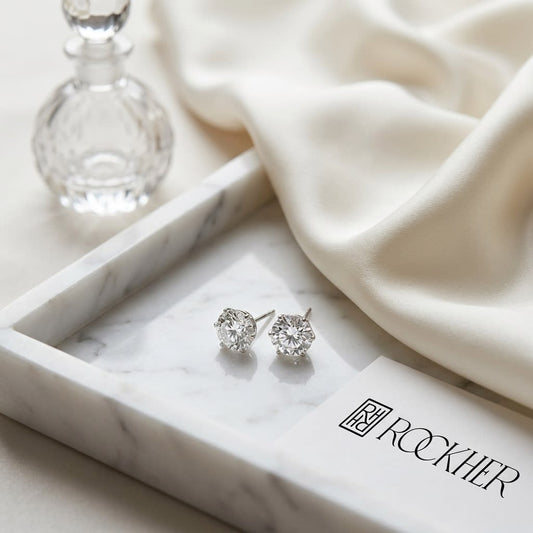 Natural Diamond Round Brilliant Stud Earrings in Platinum, 1 ct. t.w., on marble vanity tray with silk
