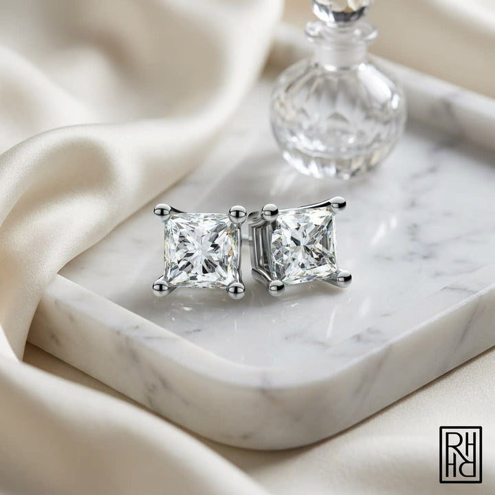 Platinum 4-prong Princess Diamond Stud Earrings (0.25 Ct. T.w., Vs1-vs2 Clarity, F-g Color), on marble vanity tray with silk