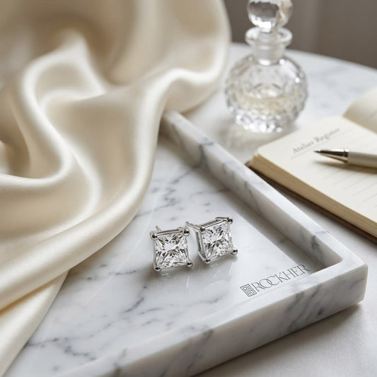 Natural Diamond Princess Cut Four Prong Stud Earrings in Platinum, 1/3 ct. t.w., on marble vanity tray with silk