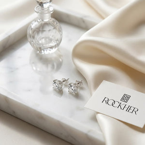 Platinum 4-prong Round Brilliant Diamond Stud Earrings (0.75 Ct. T.w., Si1-si2 Clarity, J-k Color), on marble vanity tray with silk