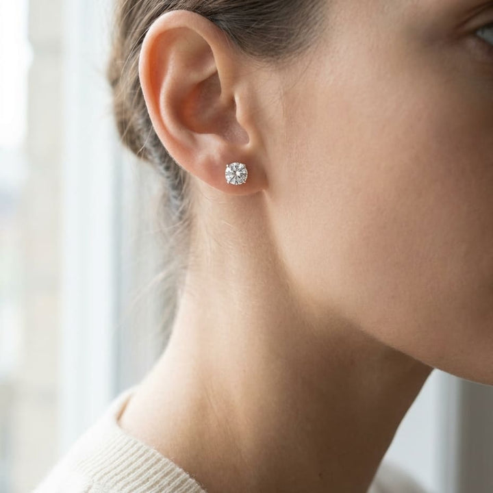 Natural Diamond Round Brilliant Four Prong Stud Earrings in Platinum, 1-1/2 ct. t.w., worn close-up portrait