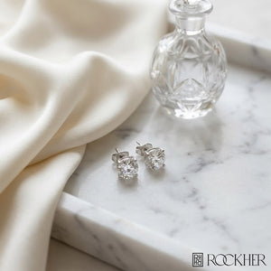 Platinum 4-prong Round Brilliant Diamond Stud Earrings (2.09 Ct. T.w., Vs1-vs2 Clarity, H-i Color), on marble vanity tray with silk