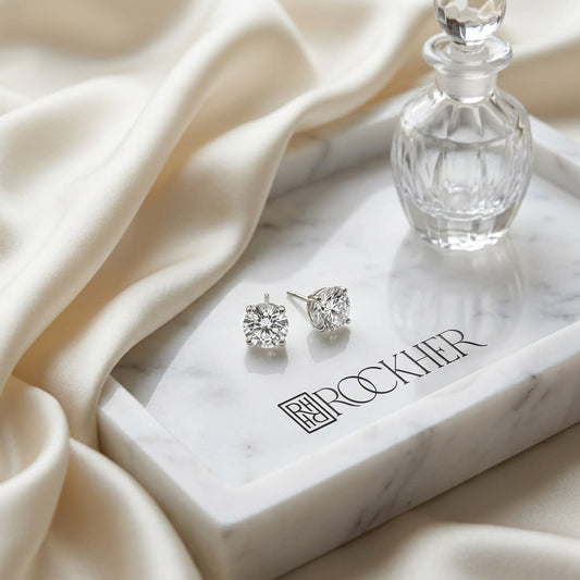 Platinum Bezel Set Round Brilliant Diamond Stud Earrings (0.22 Ct. T.w., Vs1-vs2 Clarity, F-g Color), on marble vanity tray with silk