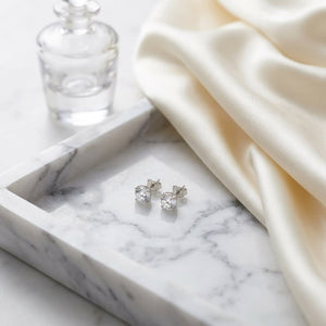 Platinum Bezel Set Round Brilliant Diamond Stud Earrings (0.22 Ct. T.w., Vs1-vs2 Clarity, H-i Color), on marble vanity tray with silk