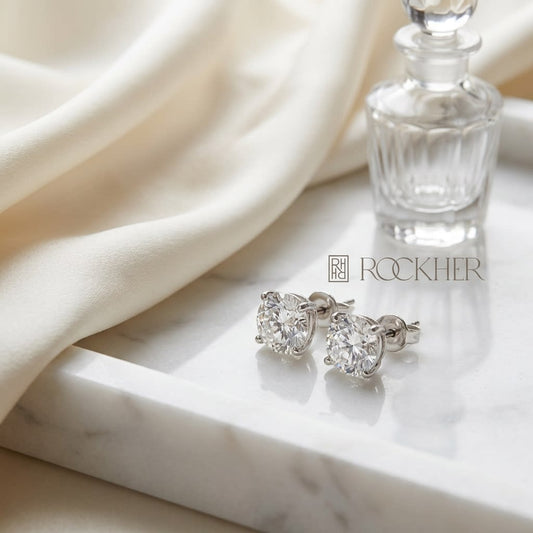 Platinum Bezel Set Round Brilliant Diamond Stud Earrings (0.5 Ct. T.w., Vs1-vs2 Clarity, H-i Color), on marble vanity tray with silk