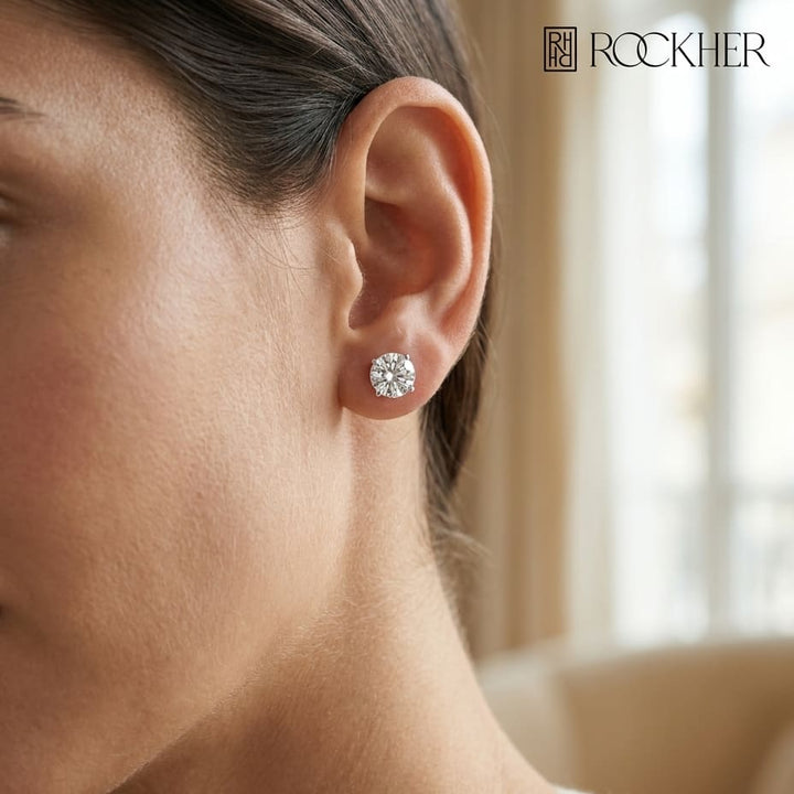 Natural Diamond Round Brilliant Bezel Stud Earrings in Platinum, 1 ct. t.w., worn close-up portrait