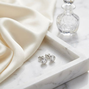 Platinum Bezel Set Round Brilliant Diamond Stud Earrings (1.47 Ct. T.w., Si1-si2 Clarity, H-i Color), on marble vanity tray with silk